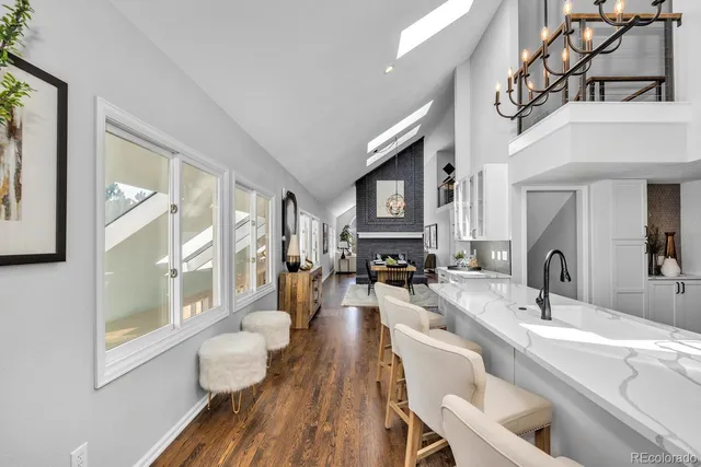 a large living room with furniture a fireplace and a large window