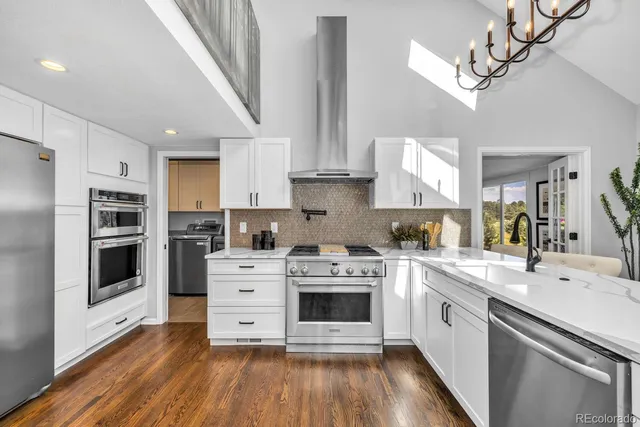 a kitchen with stainless steel appliances white cabinets and a sink