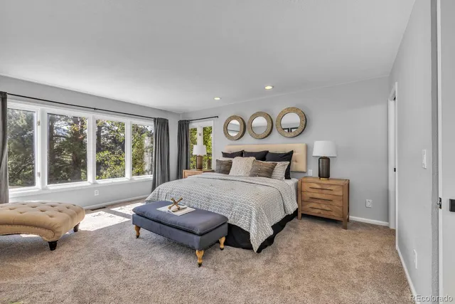 a bedroom with bed and a large window