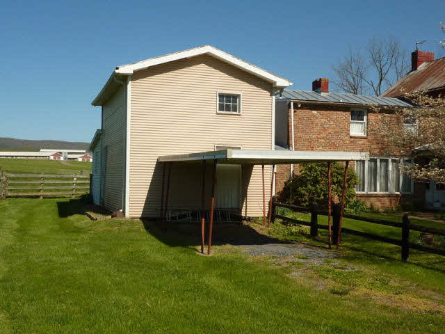 210 Wolf Ridge Road Bridgewater, VA 22812 - Photo 11 of 12 a backyard of a house with table and chairs