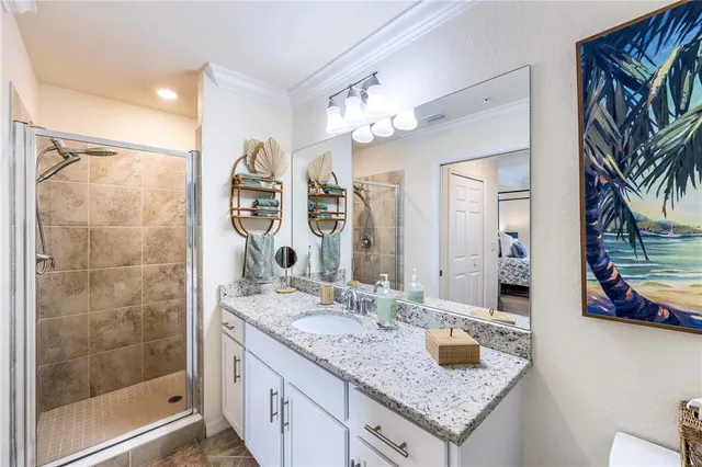 a bathroom with a granite countertop sink a mirror and shower