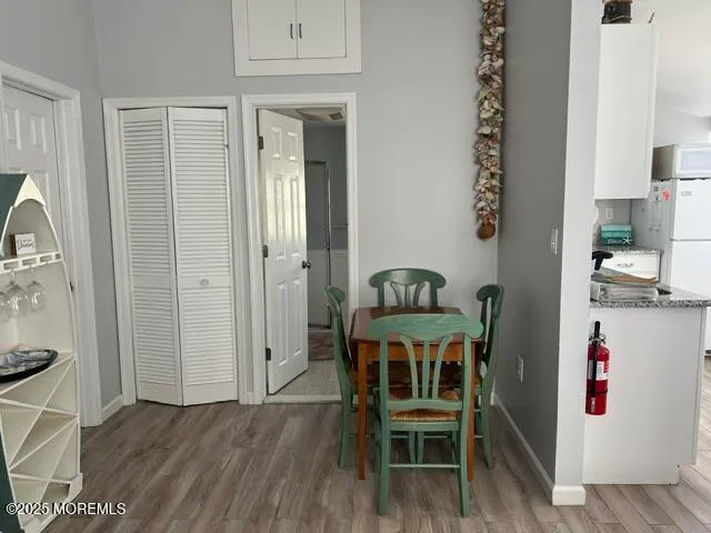 an outdoor dining space with furniture and wooden floor