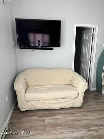 a bathroom with a bathtub and a flat screen tv