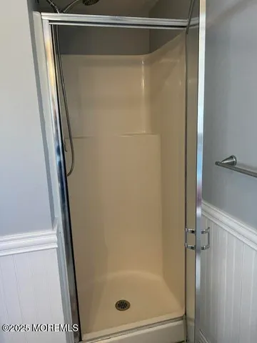 a bathroom with a glass shower door