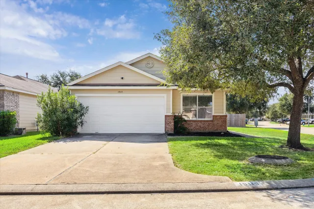 a front view of a house with a garden and yard