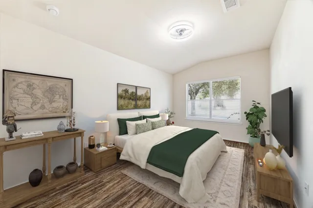 a bedroom with a bed and a flat screen tv