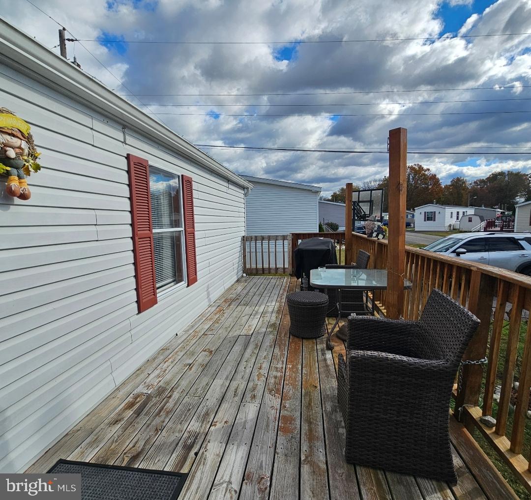2 New Bridge Road, Unit C3 Salem, NJ 08079 - Photo 13 of 14 a roof deck with table and chairs
