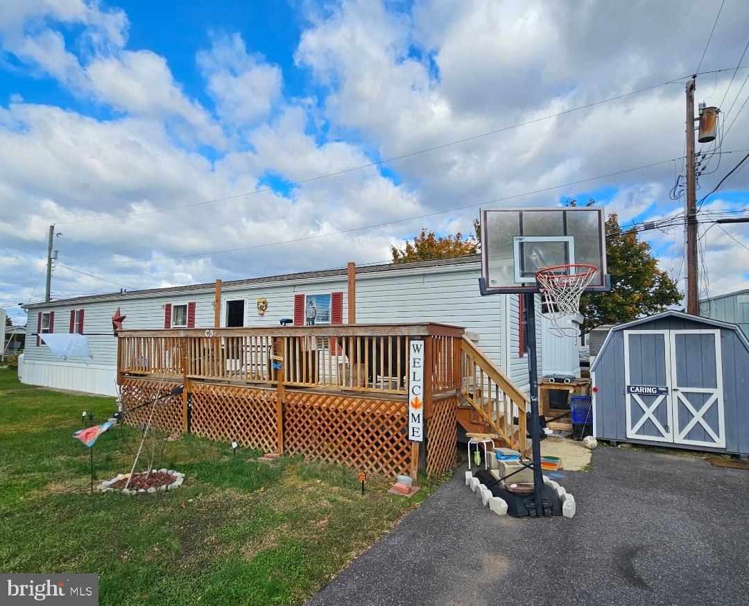2 New Bridge Road, Unit C3 Salem, NJ 08079 - Photo 3 of 14 a view of a house with a wooden deck and a yard