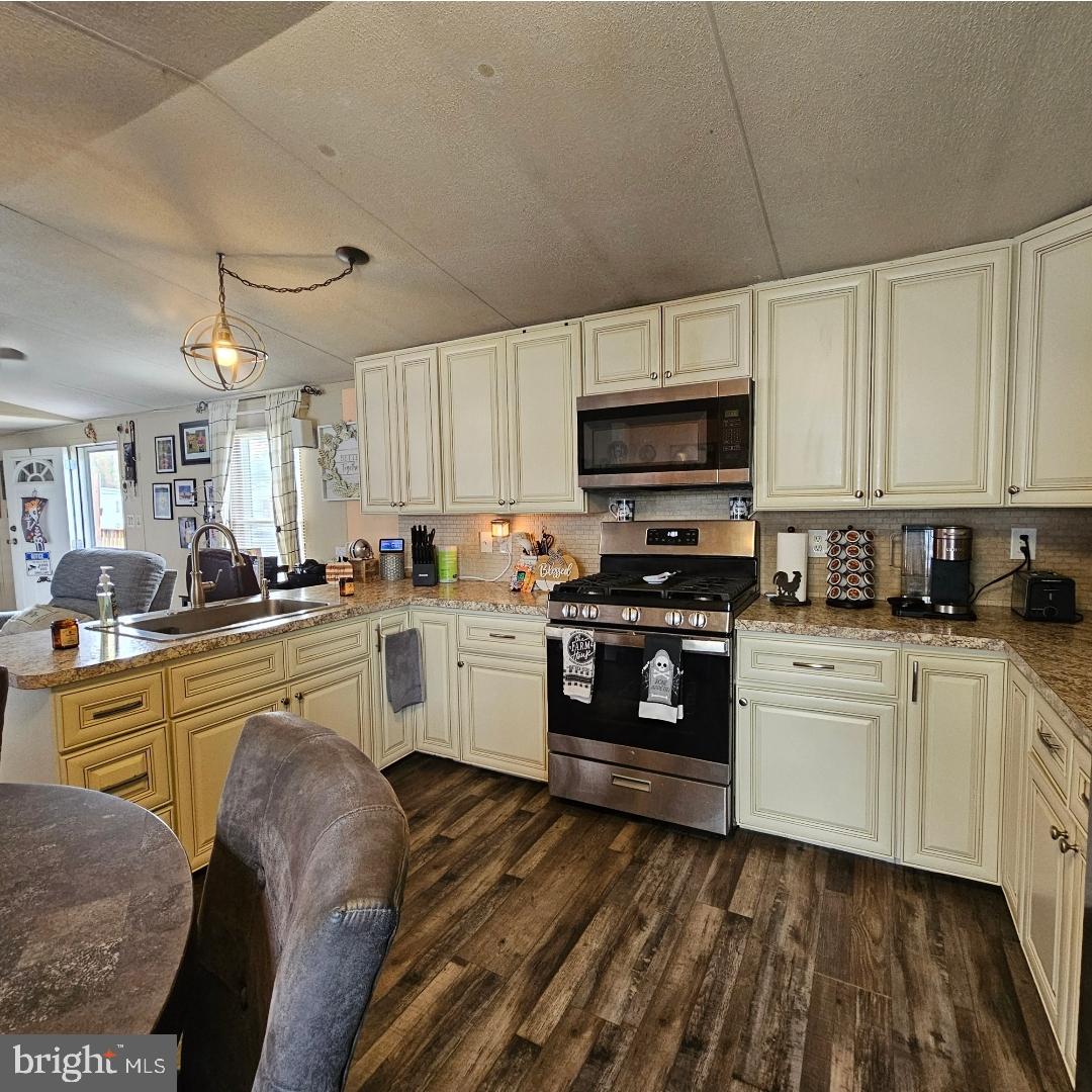 2 New Bridge Road, Unit C3 Salem, NJ 08079 - Photo 8 of 14 a kitchen with granite countertop a stove a sink and a microwave