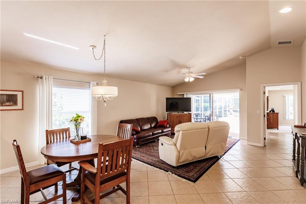 19628 Villa Rosa Loop Estero, FL 33967 - Photo 11 of 25 a living room with furniture a chandelier and a dining table