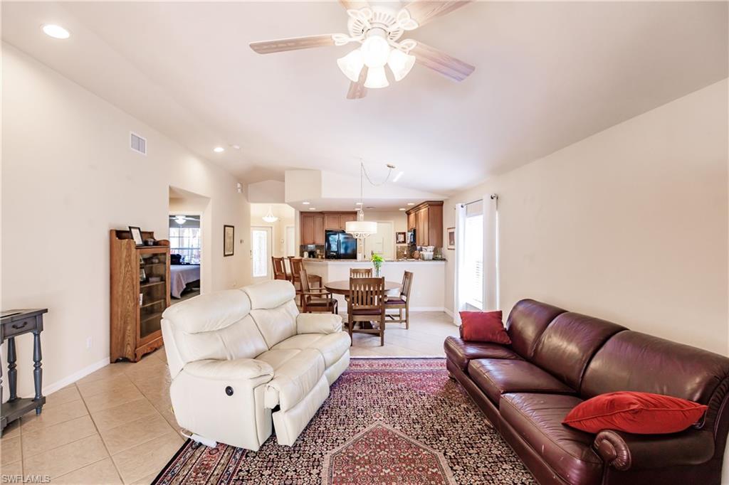 19628 Villa Rosa Loop Estero, FL 33967 - Photo 14 of 25 a living room with furniture kitchen view and a chandelier