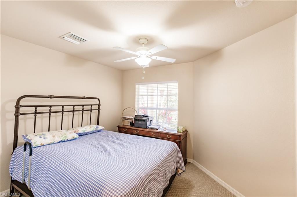 19628 Villa Rosa Loop Estero, FL 33967 - Photo 18 of 25 a bedroom with a bed and a window