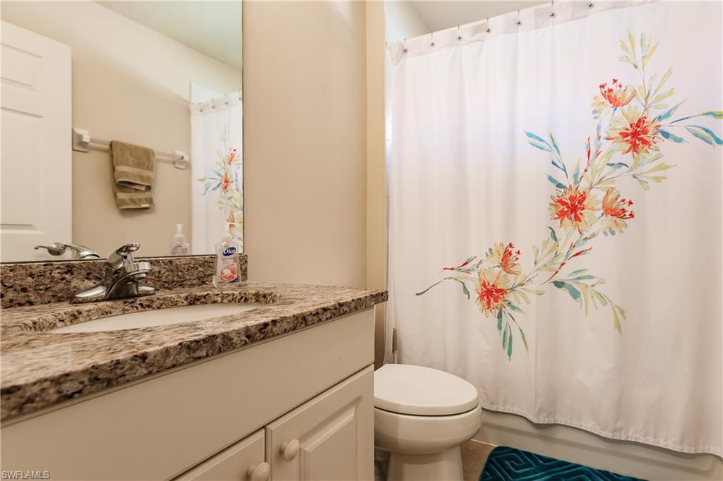 19628 Villa Rosa Loop Estero, FL 33967 - Photo 19 of 25 a bathroom with a granite countertop sink and a toilet