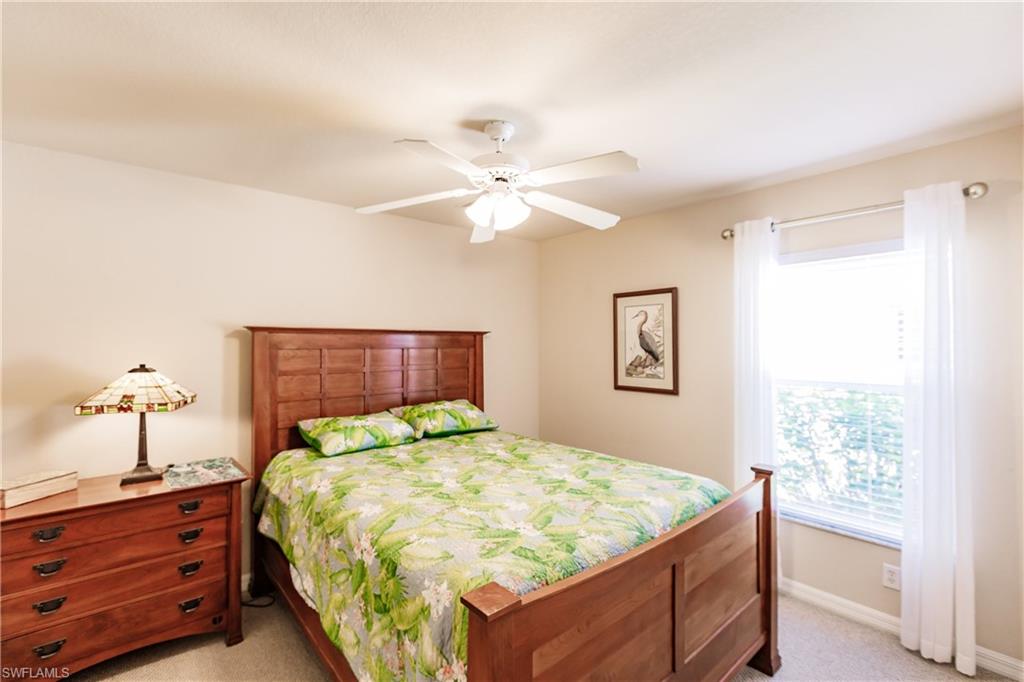 19628 Villa Rosa Loop Estero, FL 33967 - Photo 20 of 25 a bed sitting in a bedroom next to a window