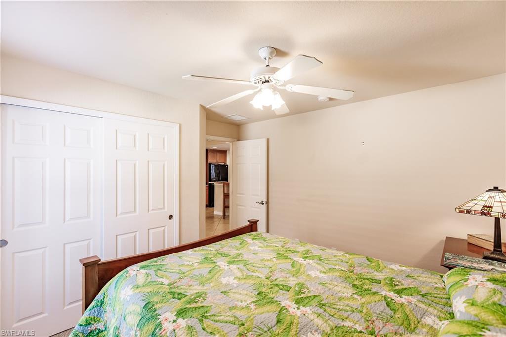 19628 Villa Rosa Loop Estero, FL 33967 - Photo 21 of 25 a bedroom with a bed and cabinets