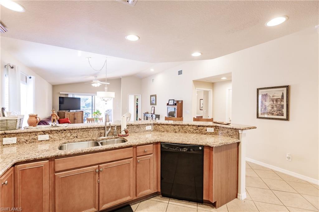 19628 Villa Rosa Loop Estero, FL 33967 - Photo 8 of 25 a kitchen with stainless steel appliances granite countertop a sink and cabinets