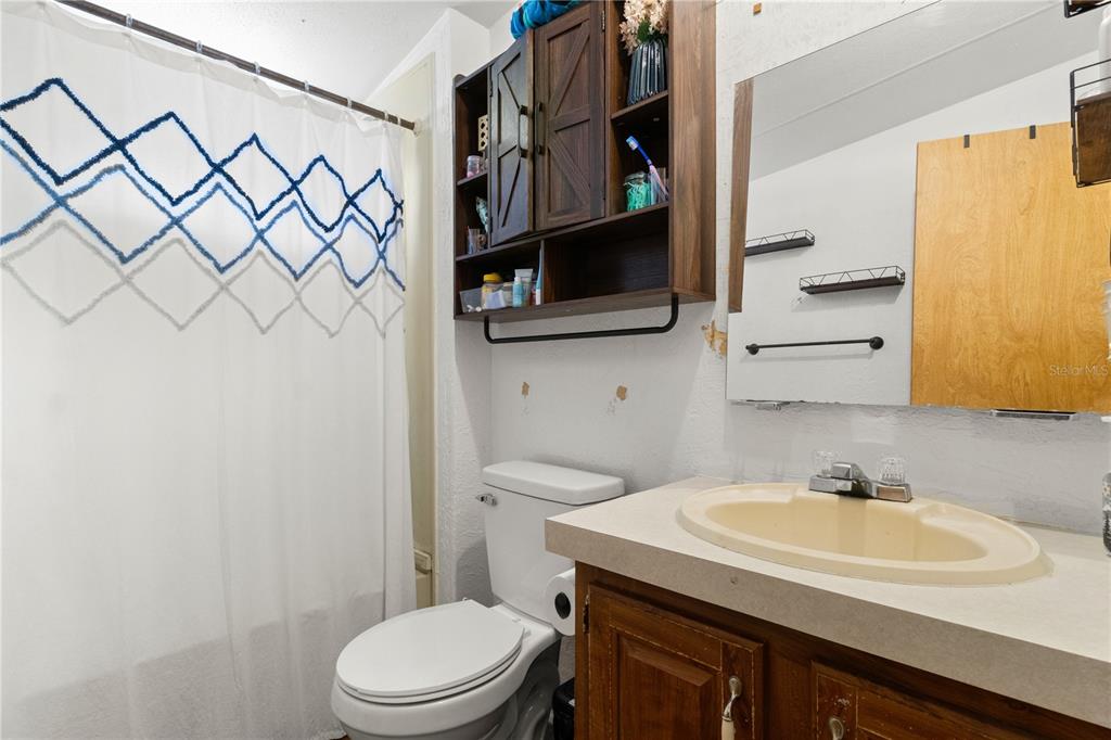 14930 Southeast 2 Lane Williston, FL 32696 - Photo 20 of 20 a bathroom with a granite countertop sink and a toilet