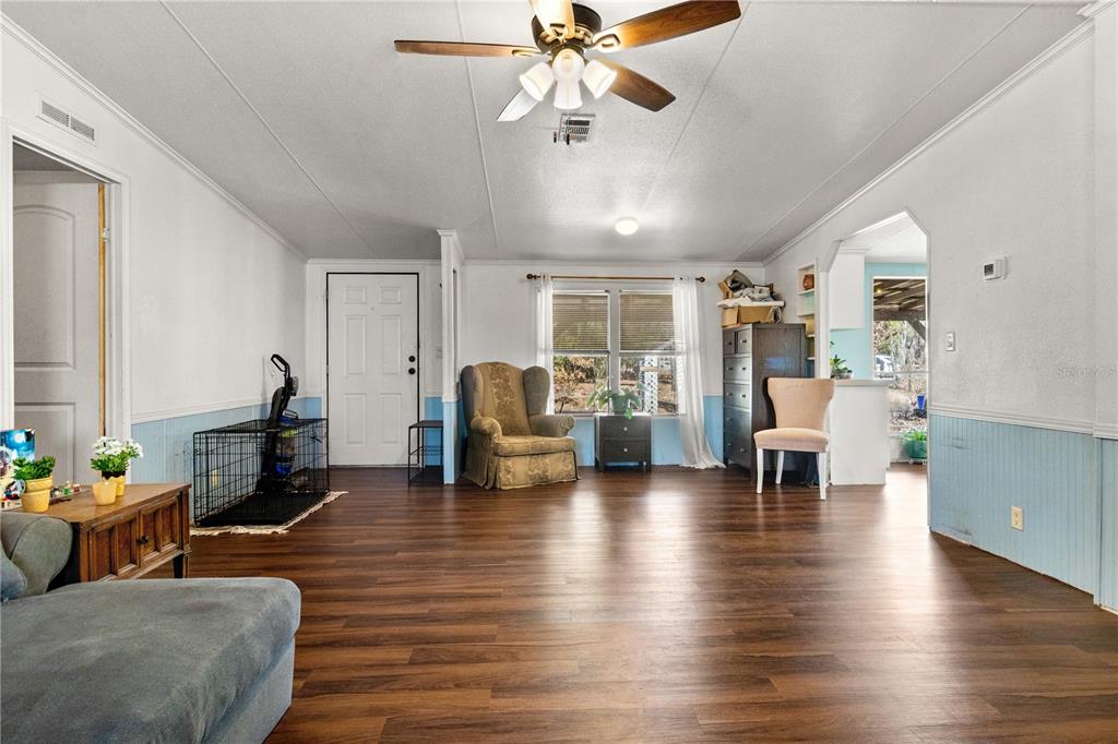 14930 Southeast 2 Lane Williston, FL 32696 - Photo 7 of 20 a living room with furniture and a chandelier
