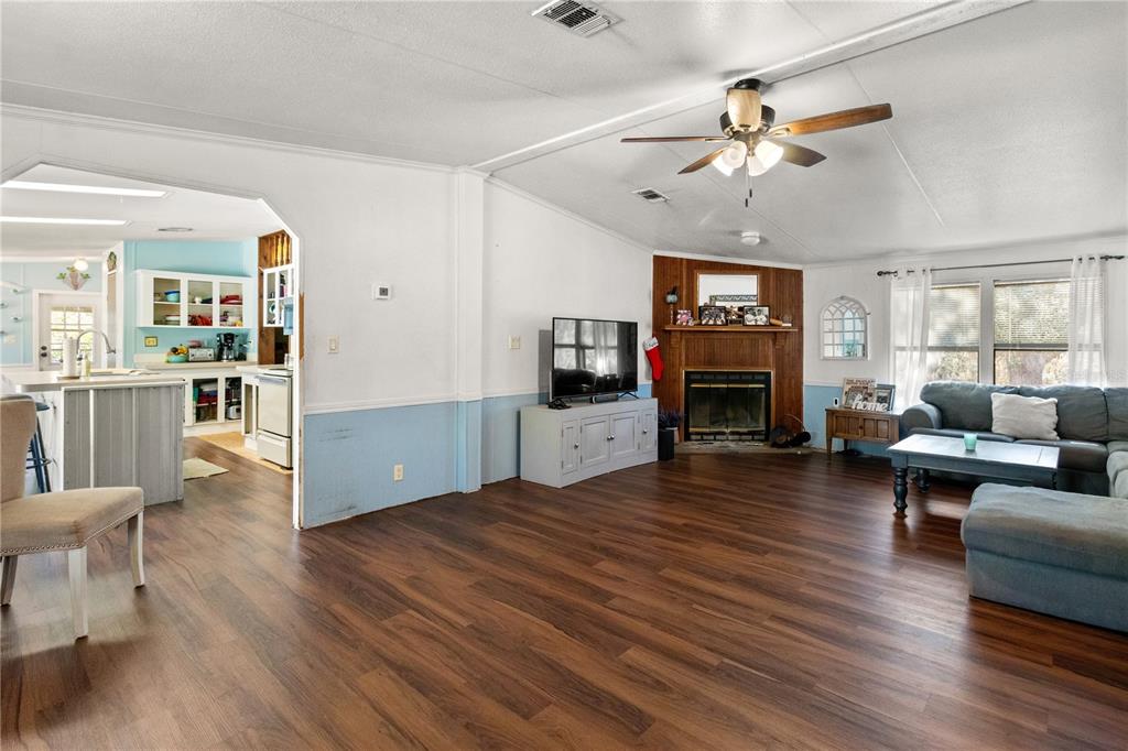 14930 Southeast 2 Lane Williston, FL 32696 - Photo 8 of 20 a living room with furniture wooden floor and a fireplace