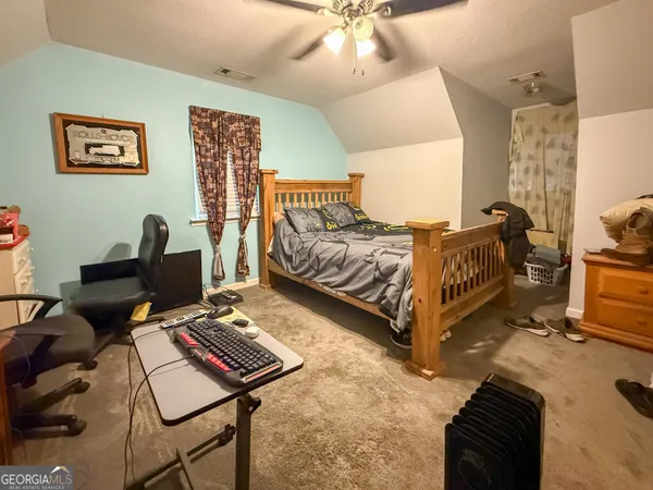 a bed room with a bed and a chair