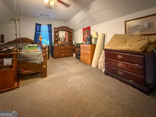 a view of a room with furniture closet and a ceiling fan