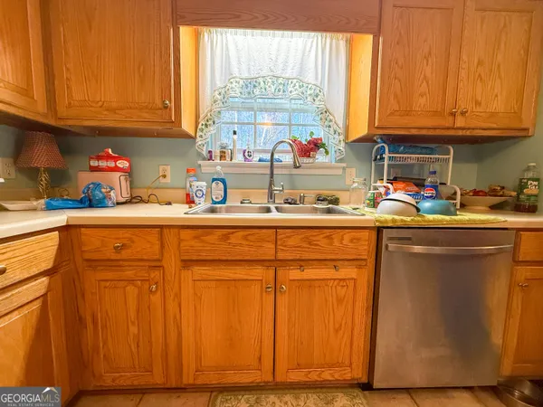a kitchen with stainless steel appliances granite countertop a sink cabinets and a window
