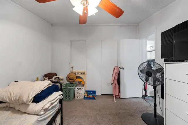 a bedroom with bed and a chandelier