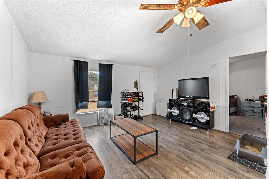 17558 Caufield Road Spring Hill, FL 34610 - Photo 5 of 20 a bedroom with furniture and a flat screen tv