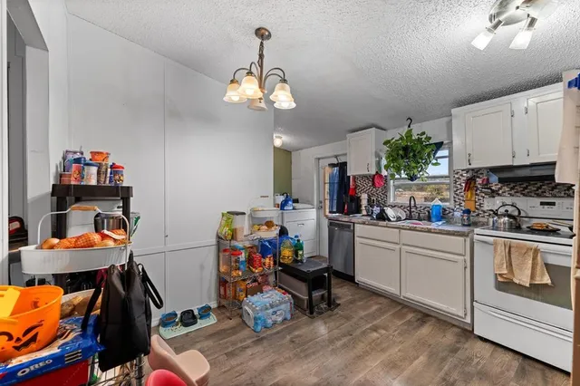 a kitchen with a refrigerator and a sink