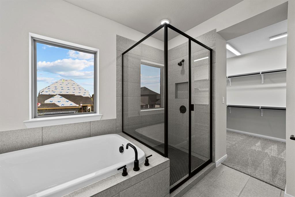 2044 Cuellar Way Van Alstyne, TX 75495 - Photo 11 of 30 a bathroom with a bathtub and a shower