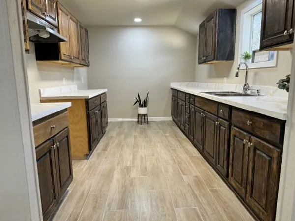 a bathroom with a sink vanity and mirror