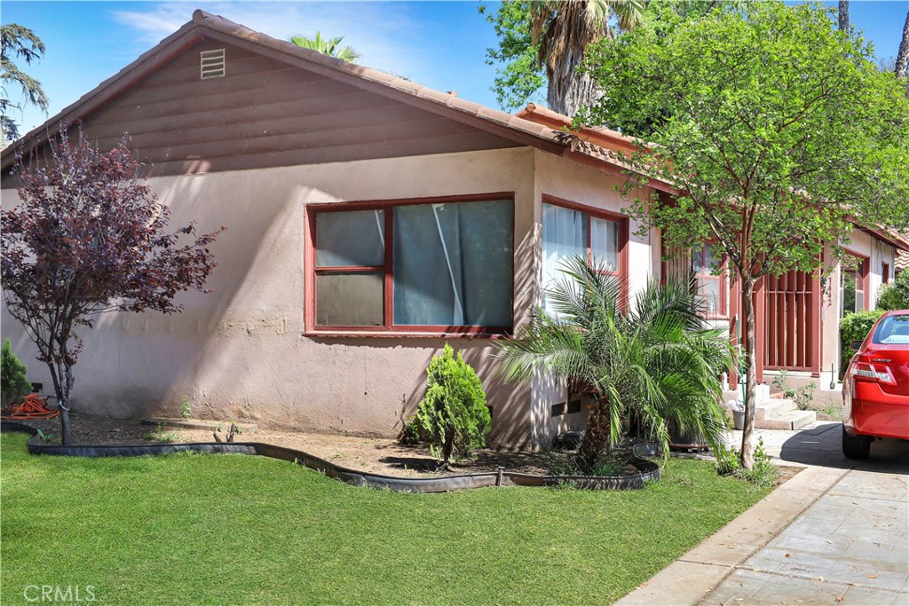 7442 Potomac Street Riverside, CA 92504 - Photo 3 of 7 a front view of a house with garden