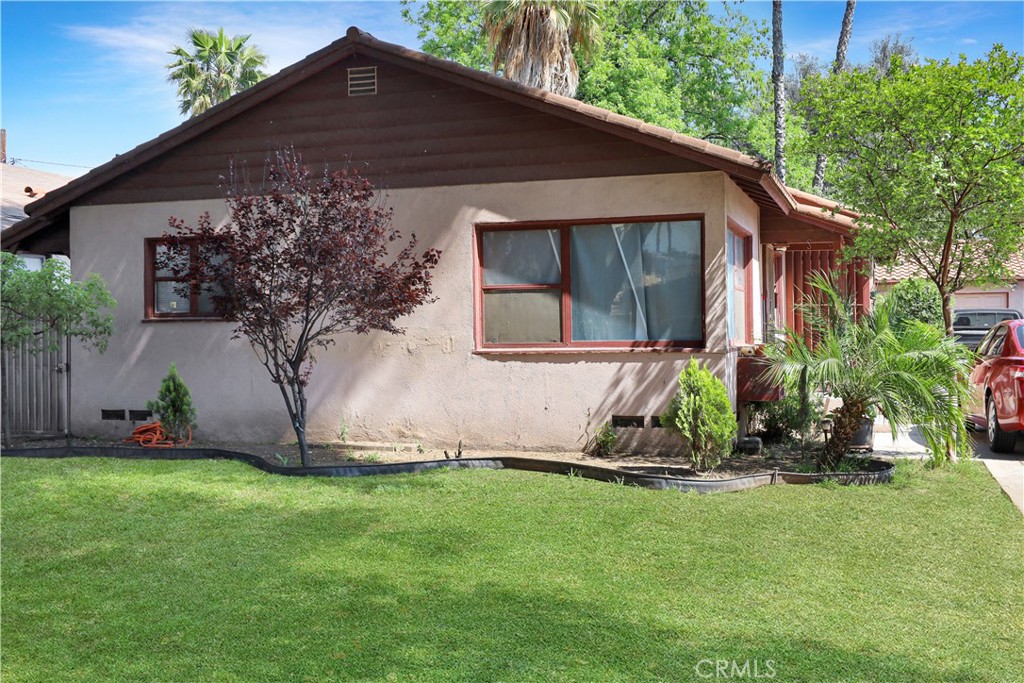 7442 Potomac Street Riverside, CA 92504 - Photo 4 of 7 a front view of a house with a garden and yard