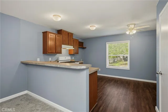 a kitchen with a sink cabinets and wooden floor