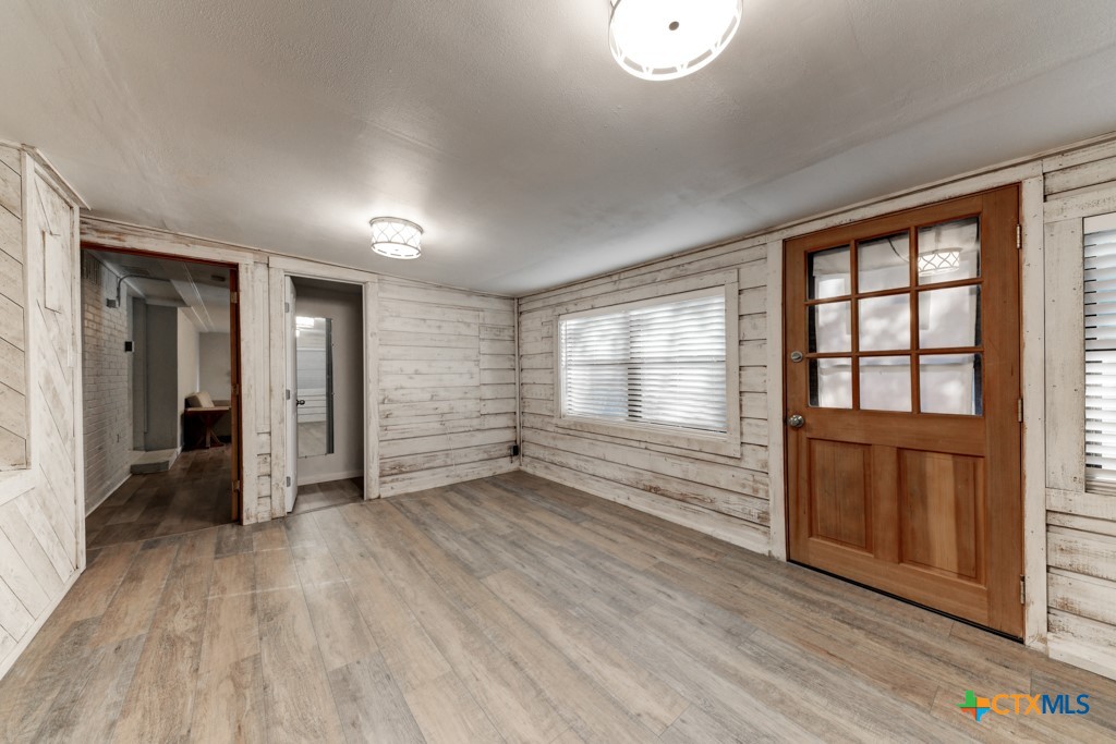 1229 Rapids Road New Braunfels, TX 78130 - Photo 21 of 27 an empty room with wooden floor and windows