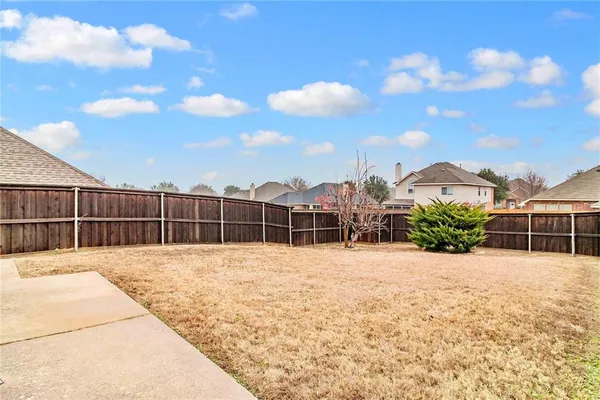 a view of a house with a wooden fence