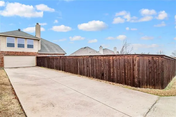 a sign board with tall trees