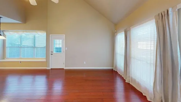 a view of a room with wooden floor and a tub
