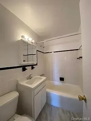 a bathroom with a sink a toilet and bathtub