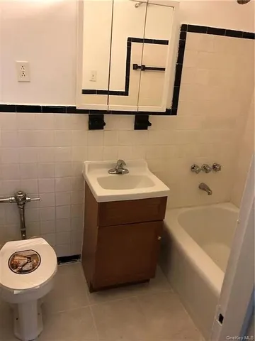 a bathroom with a sink a toilet and bathtub