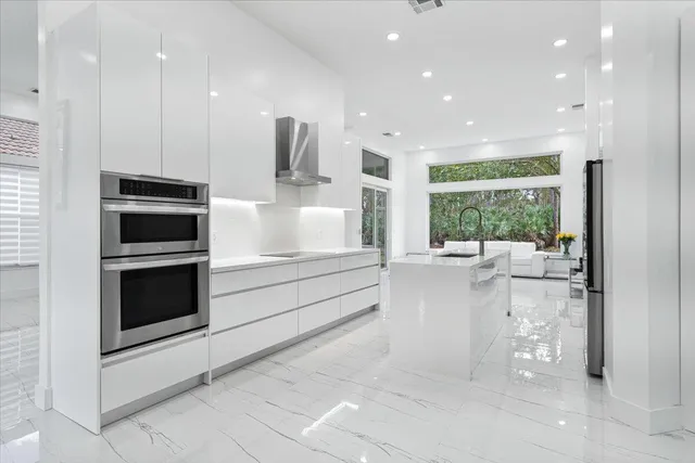 a kitchen with stainless steel appliances a refrigerator and a stove