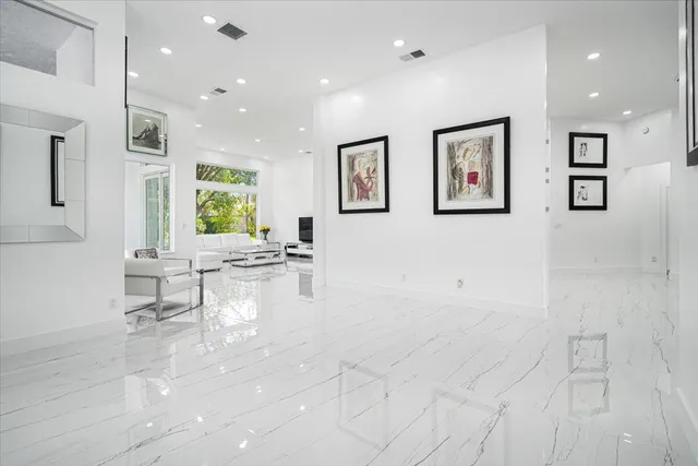 a spacious bedroom with a bed and a flat screen television