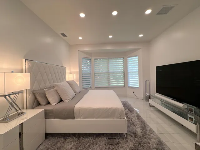 a bedroom with a bed and a window