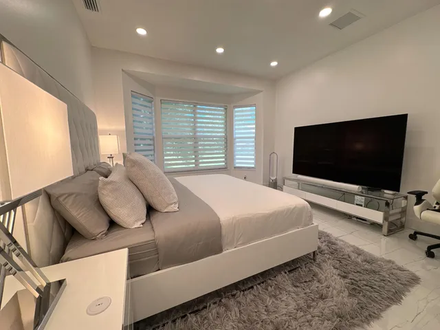 a large bed sitting in a bedroom and closet