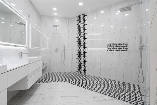 a bathroom with a sink a toilet and shower