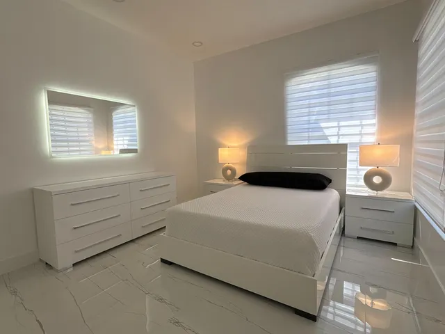 a view of a yard with plants and trees