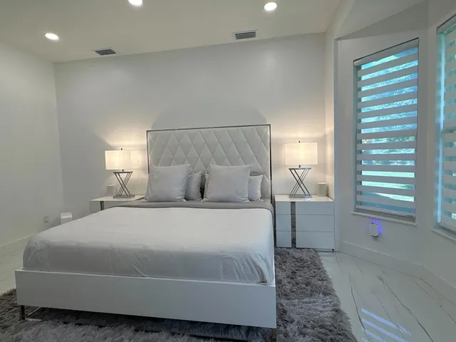 an aerial view of a house with a garden and lake view