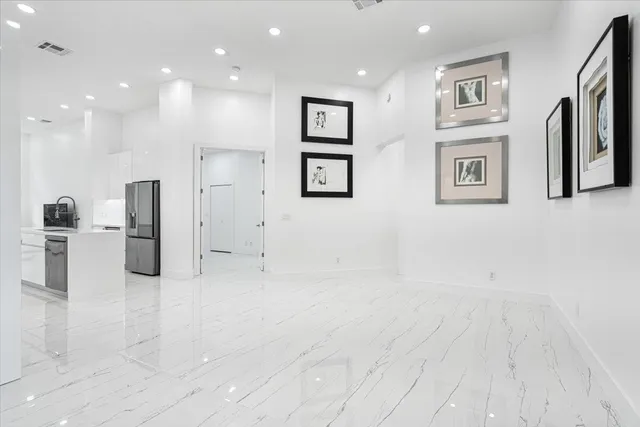 an empty room with windows and closet