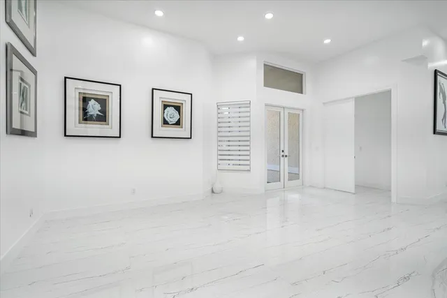 a view of a dining room with furniture and a potted plant