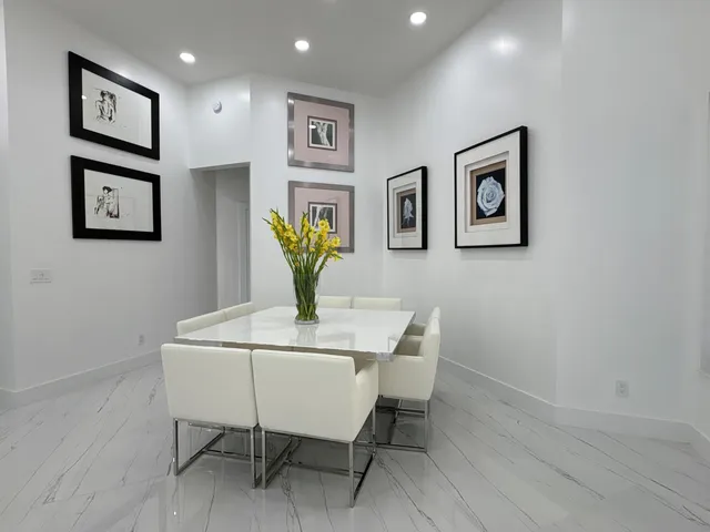 a view of entryway with paintings on the wall